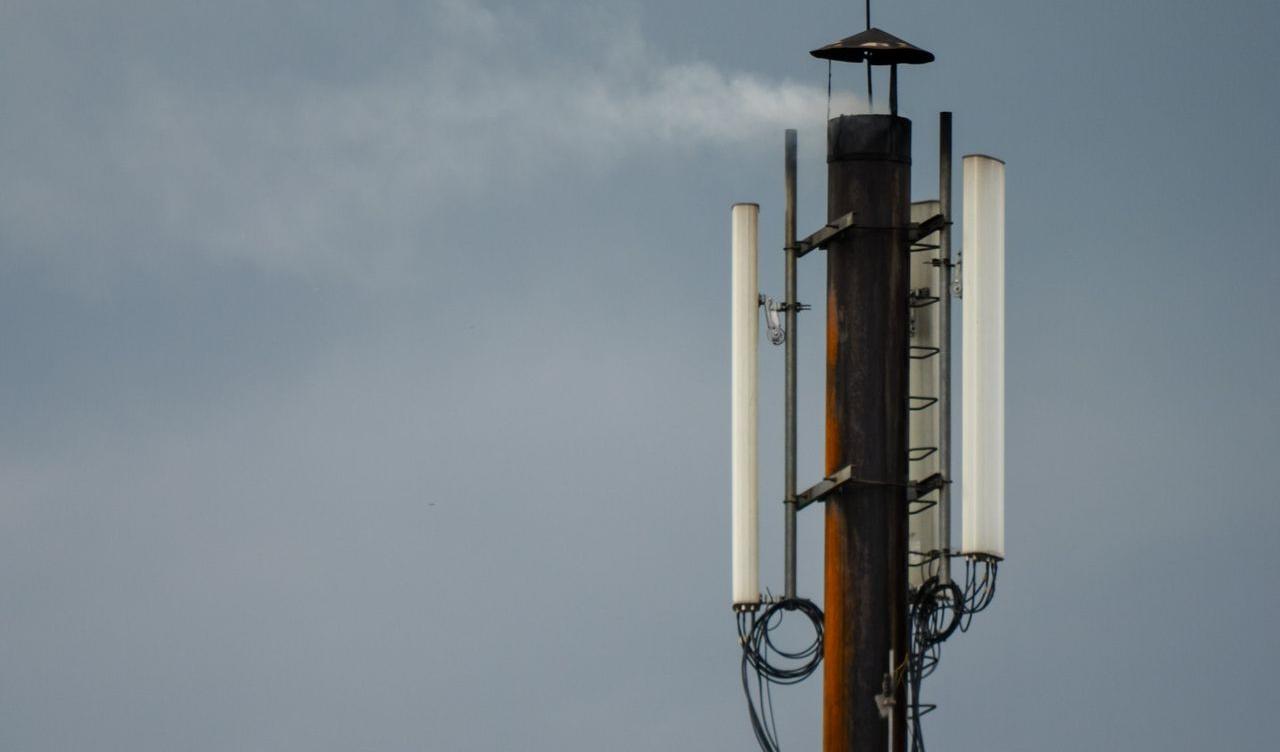 a cell phone tower with a sky background