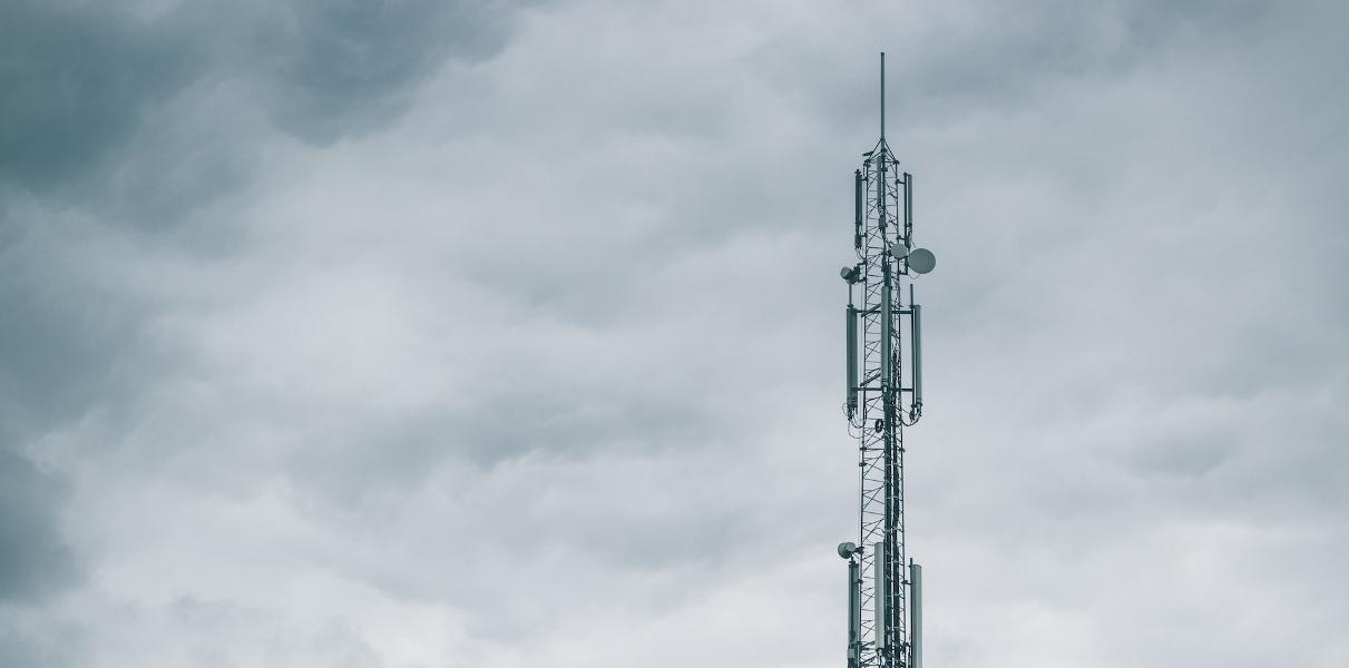 gray radio tower under the cloudy sky during daytime